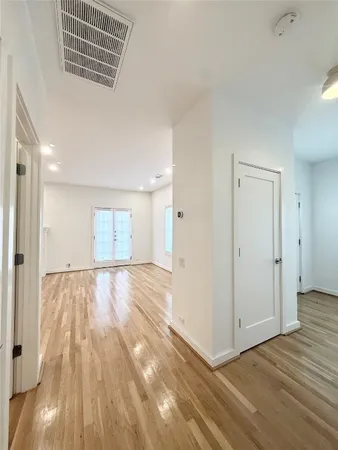 a view of an empty room and wooden floor
