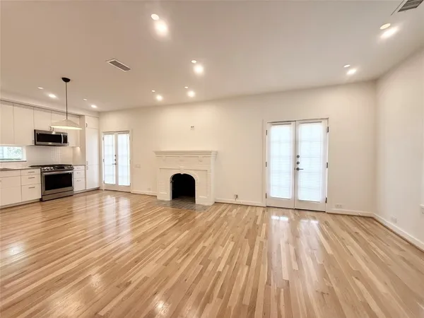 a view of kitchen with granite countertop cabinets and refrigerator