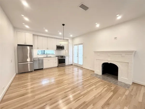 a kitchen with stainless steel appliances a stove refrigerator sink and microwave