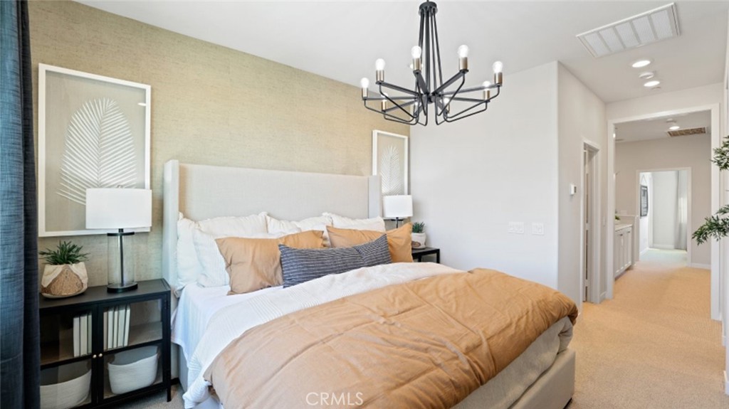 61 Harness Way Rancho Mission Viejo, CA 92694 - Photo 12 of 25 a bedroom with bed and a chandelier