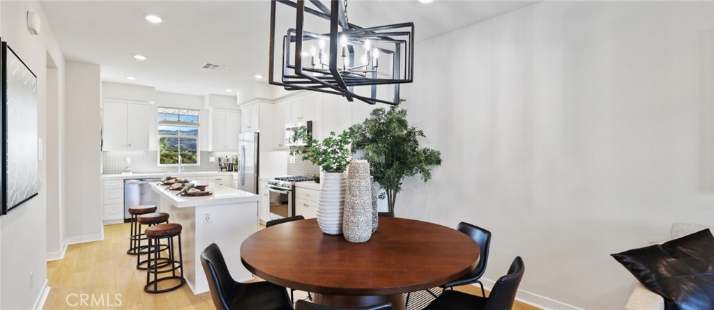 61 Harness Way Rancho Mission Viejo, CA 92694 - Photo 6 of 25 a view of a dining room with furniture and wooden floor
