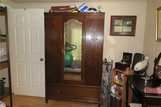 a bedroom with a large bed and a chandelier