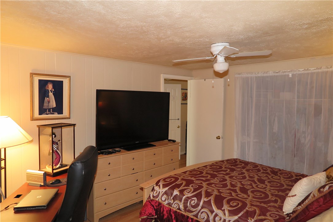 1310 Pine Street Georgetown, TX 78626 - Photo 13 of 14 a bedroom with a bed and a flat screen tv