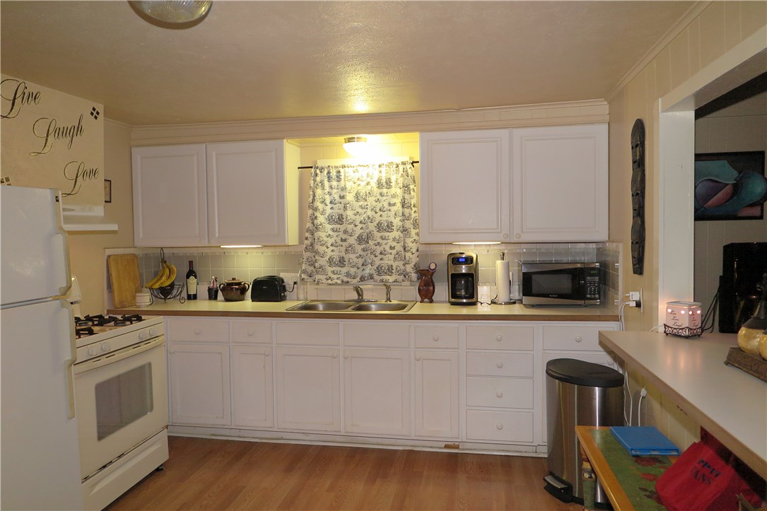1310 Pine Street Georgetown, TX 78626 - Photo 6 of 14 a kitchen with stainless steel appliances a stove a sink a refrigerator and cabinets