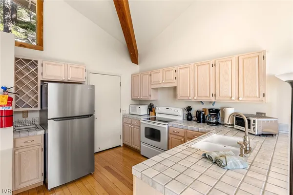 a kitchen with a refrigerator sink and stove top oven