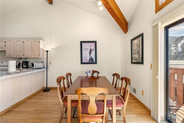 a dining room with furniture and wooden floor