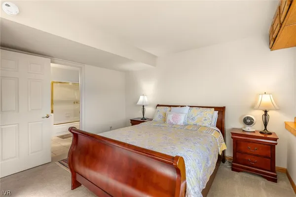 a bedroom with a bed and a lamp