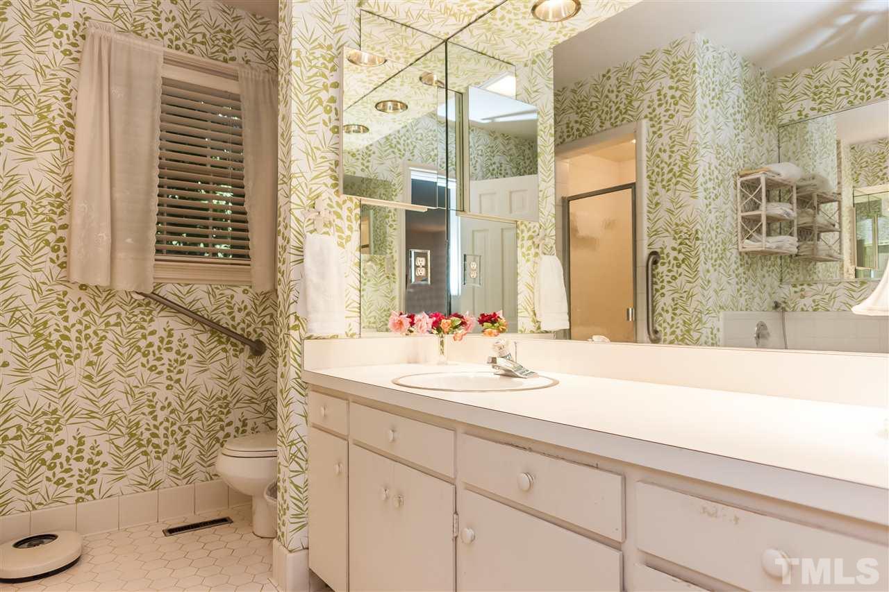 3313 Landor Road Raleigh, NC 27609 - Photo 15 of 25 a bathroom with a sink and a mirror with toilet