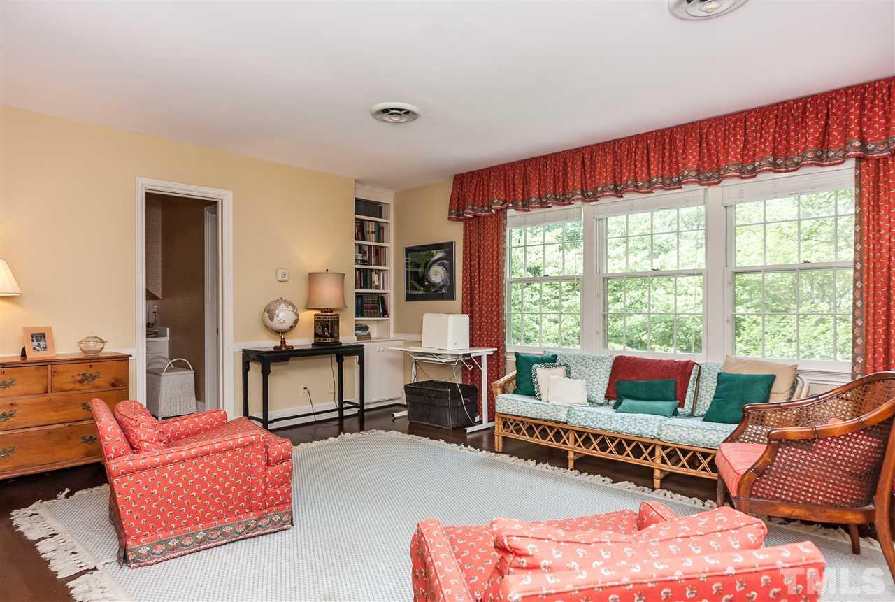 3313 Landor Road Raleigh, NC 27609 - Photo 18 of 25 a living room with furniture a flat screen tv and large windows