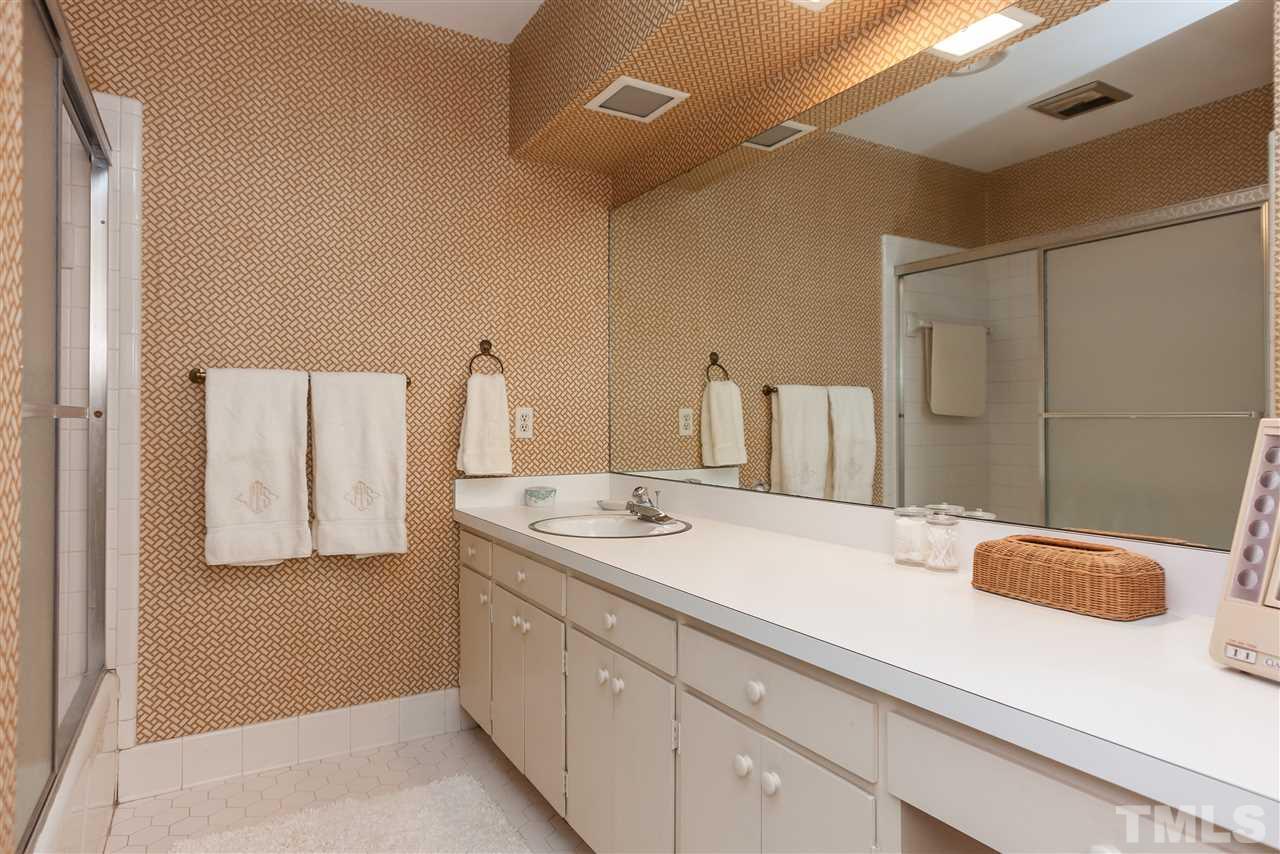 3313 Landor Road Raleigh, NC 27609 - Photo 20 of 25 a bathroom with a sink and a mirror
