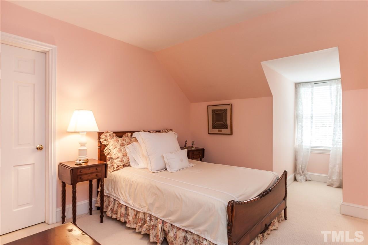 3313 Landor Road Raleigh, NC 27609 - Photo 23 of 25 a bedroom with a bed and a night stand