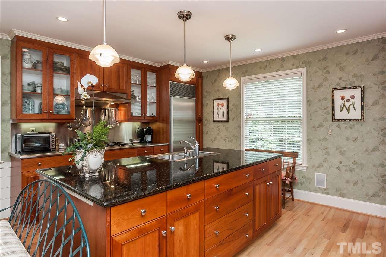 3313 Landor Road Raleigh, NC 27609 - Photo 9 of 25 a kitchen with stainless steel appliances granite countertop a stove a sink and a granite counter tops