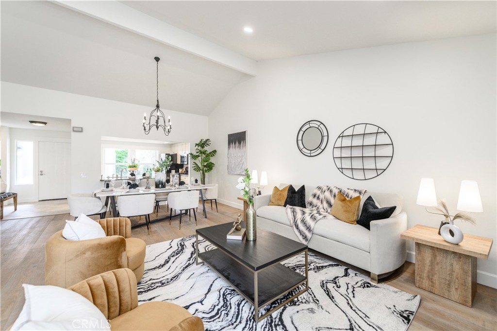 a living room with furniture a table and a chandelier