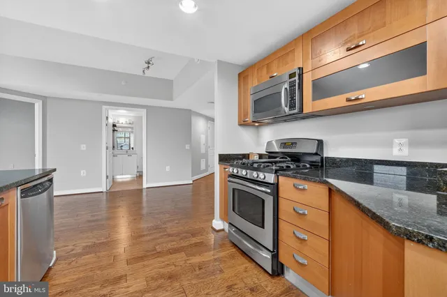 a kitchen with stainless steel appliances granite countertop a stove and a sink