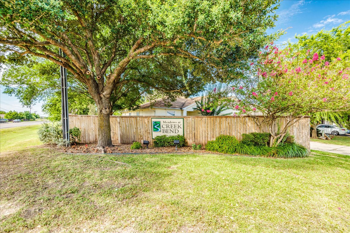 100 Easy Street Hutto, TX 78634 - Photo 31 of 36 Mature trees and vibrant shrubbery frame the welcoming entry to this community.
