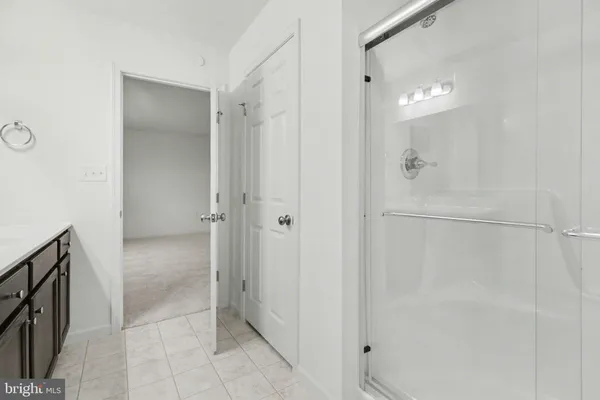 a bathroom with a shower and a glass door
