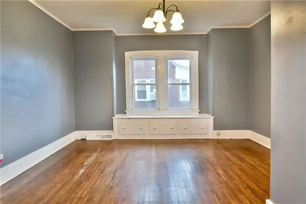 a view of a room with wooden floor and cabinet