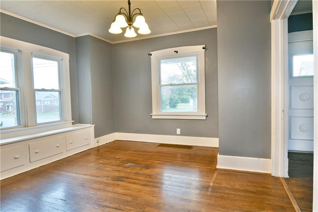 1107 West Ridge Avenue Sharpsville, PA 16150 - Photo 13 of 48 an empty room with wooden floor chandelier and windows