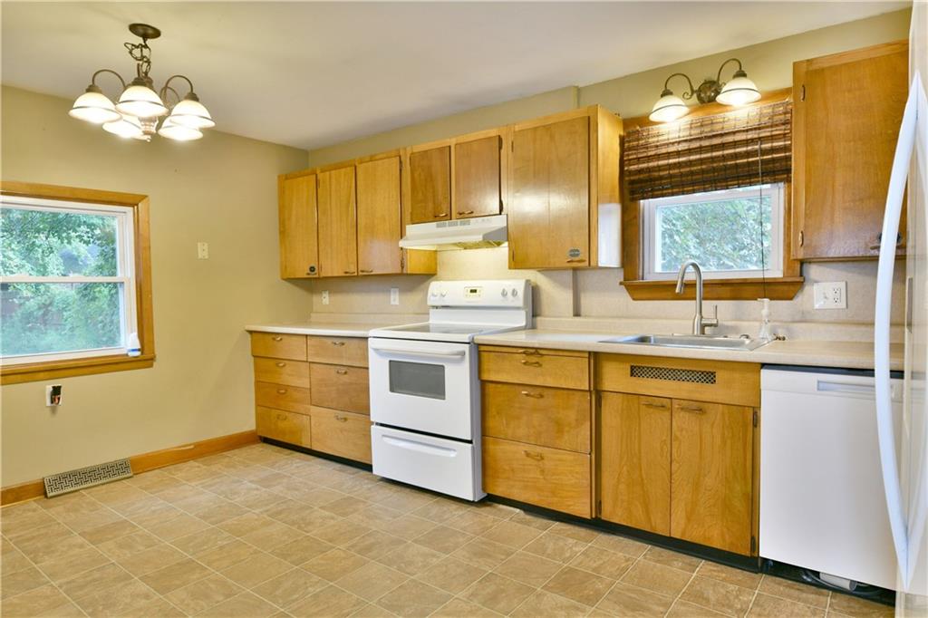 1107 West Ridge Avenue Sharpsville, PA 16150 - Photo 15 of 48 a kitchen with granite countertop a sink cabinets stainless steel appliances and a window