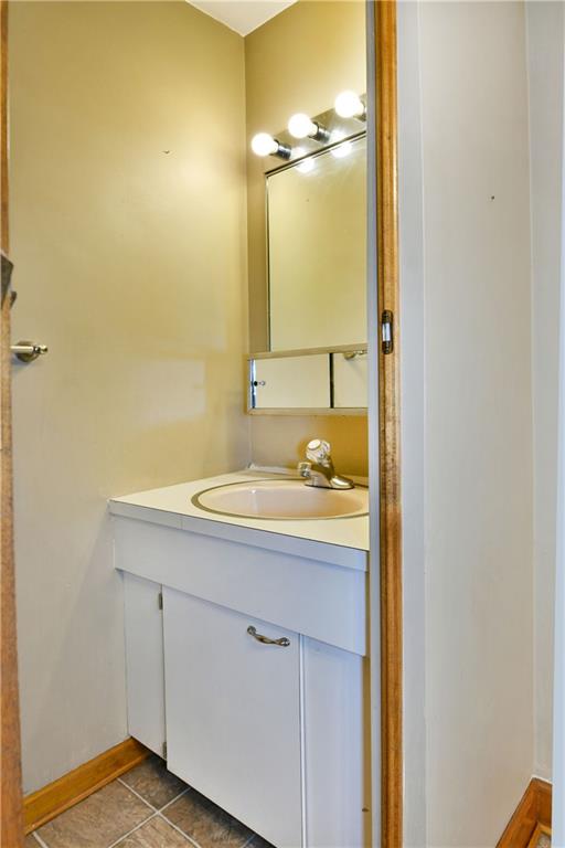1107 West Ridge Avenue Sharpsville, PA 16150 - Photo 20 of 48 a bathroom with a granite countertop sink and a mirror