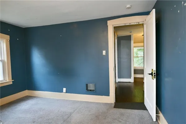 a bathroom with a bathtub and next to a window
