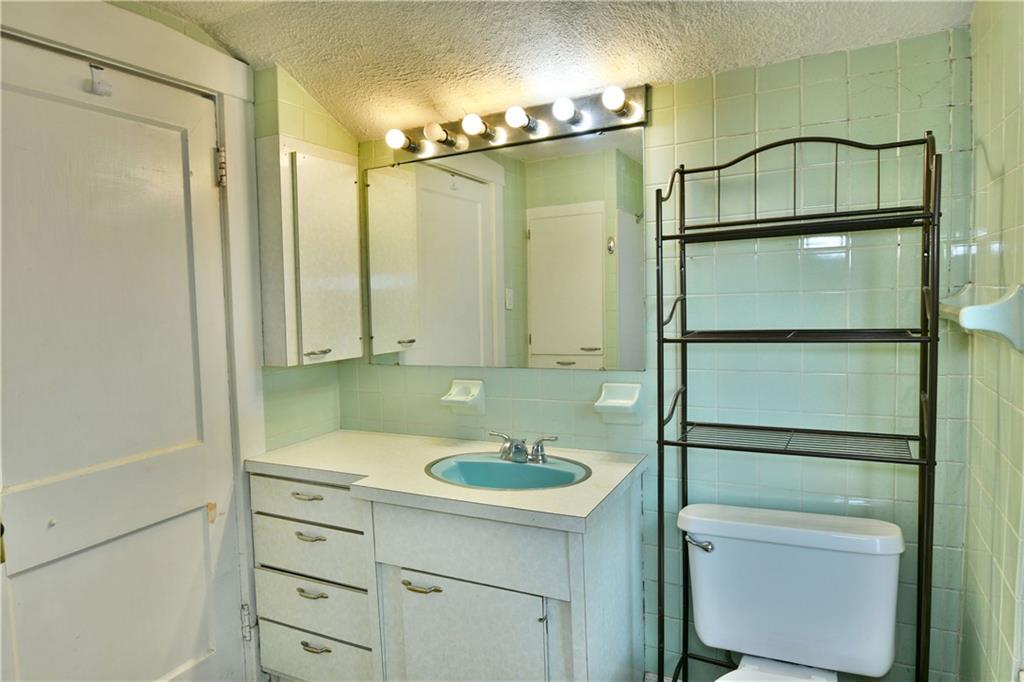 1107 West Ridge Avenue Sharpsville, PA 16150 - Photo 35 of 48 a bathroom with a sink a toilet and shower