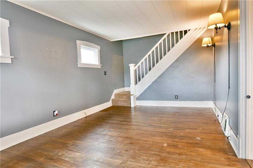 1107 West Ridge Avenue Sharpsville, PA 16150 - Photo 4 of 48 a view of a room with wooden floor and staircase