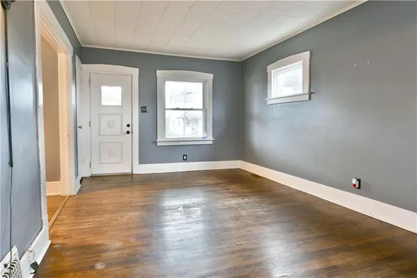 wooden floor in an empty room with a window