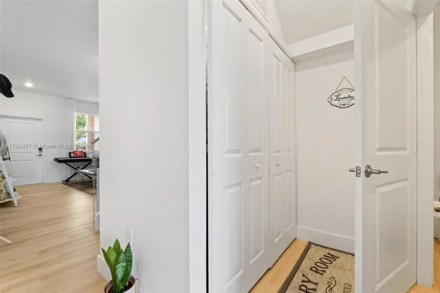 a view of a study room and hallway with wooden floor