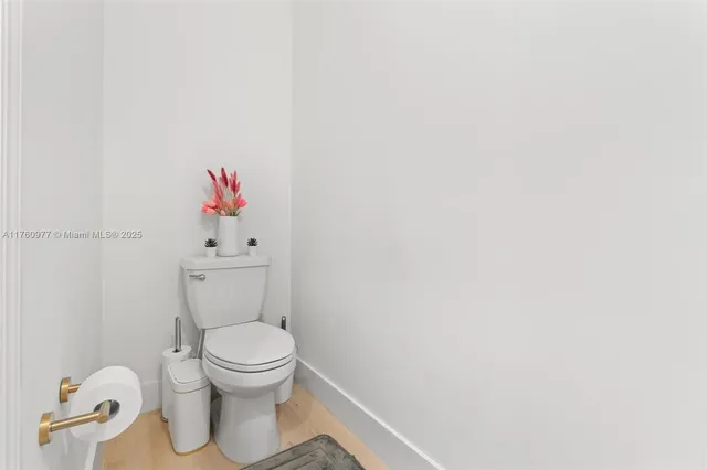 a white toilet and a shower curtain