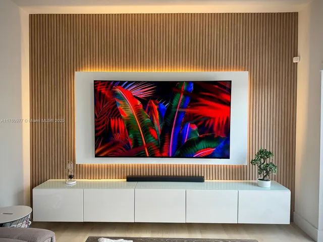 a living room with a couch and a wall painting