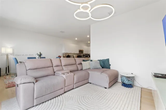 a large bedroom with a bed and chandelier