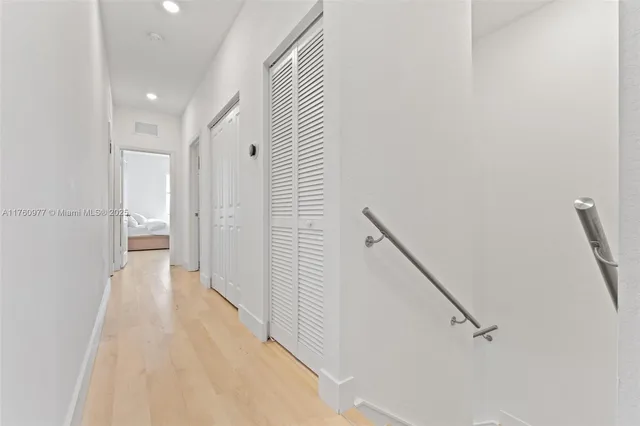 a view of a hallway with wooden floor