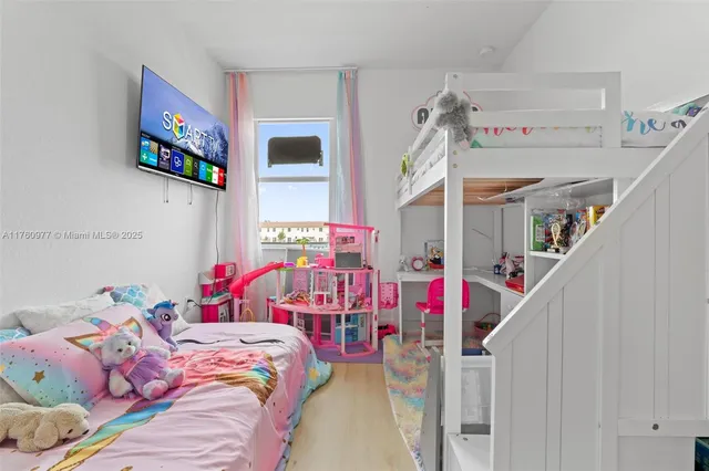 a bedroom with bed and a chandelier