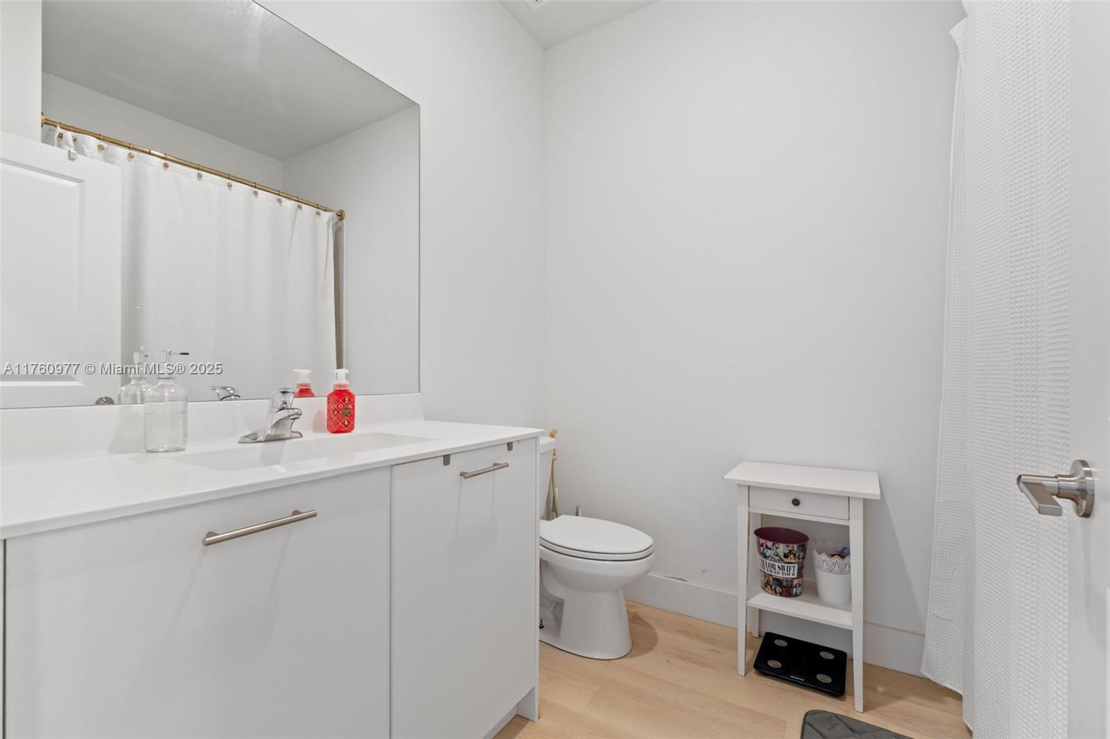 12824 Northwest 22nd Place, Unit 12824 Miami, FL 33167 - Photo 35 of 47 a bathroom with a sink vanity mirror and toilet