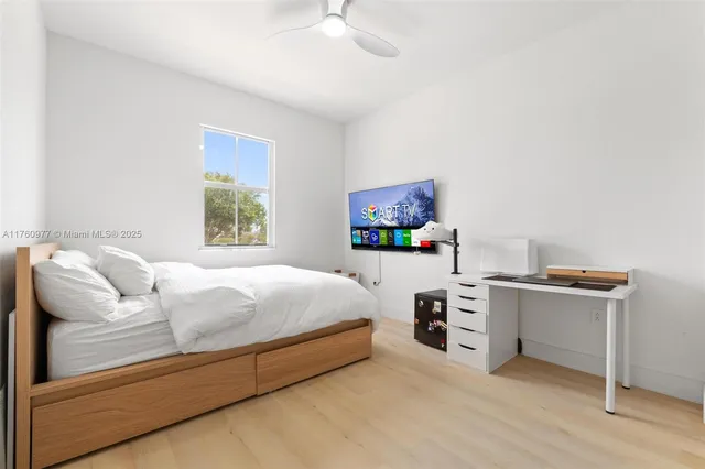 a bedroom with a bed and a desk