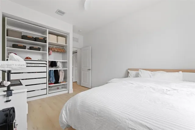 a large white bed in a white room