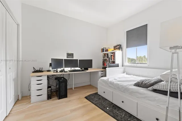 a bedroom with a bed and a television