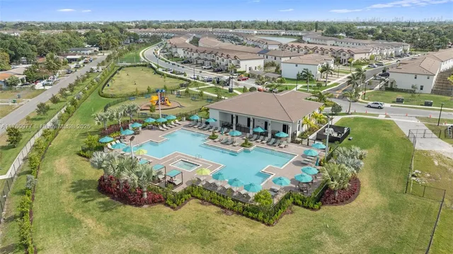 an aerial view of a house with garden space and ocean view