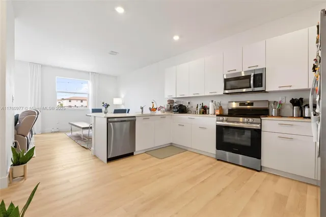 a kitchen with a stove top oven sink and cabinets