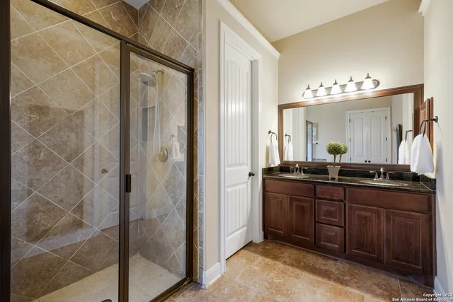 a bathroom with a double vanity sink and a mirror