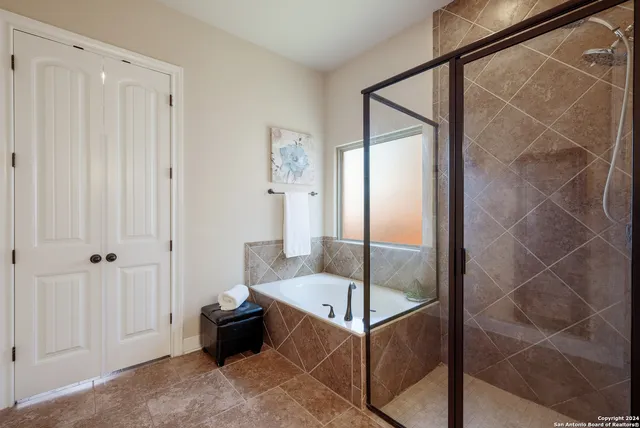 a bathroom with a tub and shower
