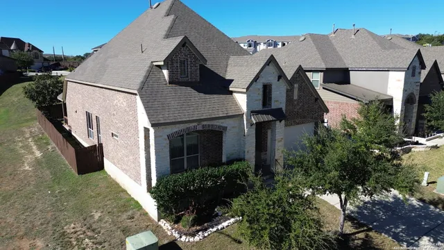 a aerial view of a house with a yard and potted plants