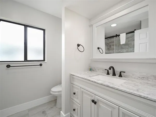 a kitchen with a refrigerator and a stove top oven