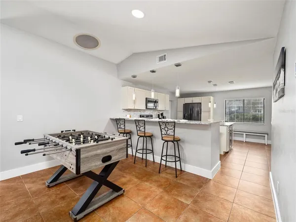 a kitchen with granite countertop sink table and chairs