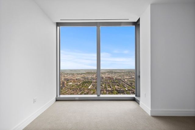 an empty room with large windows
