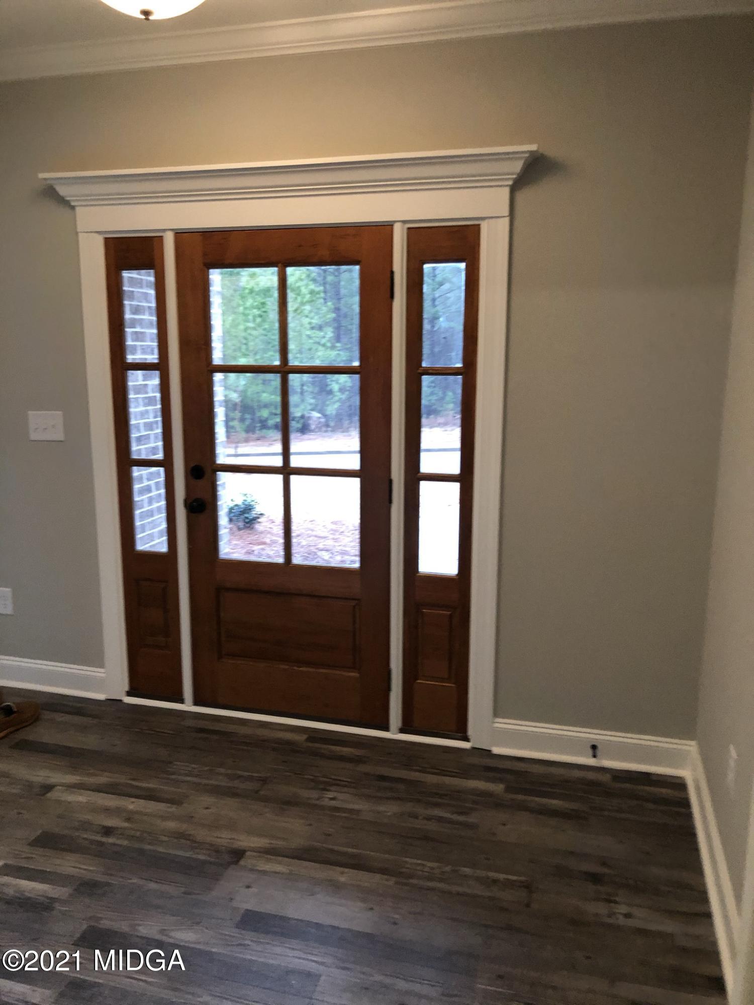 85 Adam Drive Forsyth, GA 31029 - Photo 2 of 18 a view of empty room with wooden floor and fan