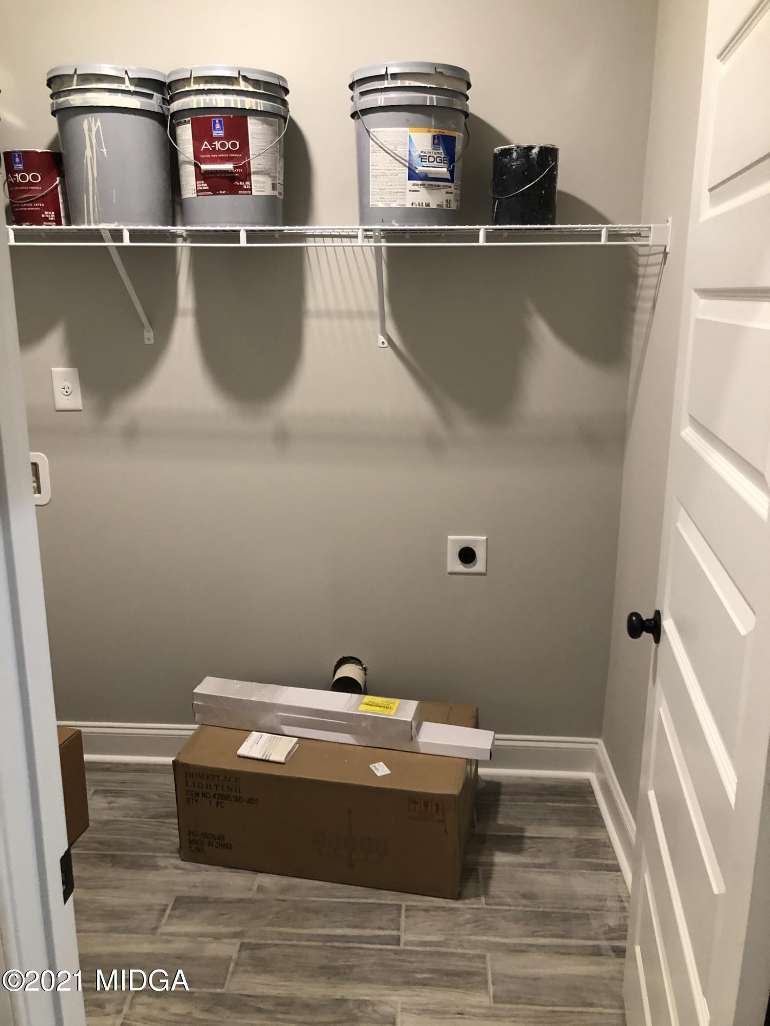 85 Adam Drive Forsyth, GA 31029 - Photo 12 of 18 a room with water heater and wooden cabinets