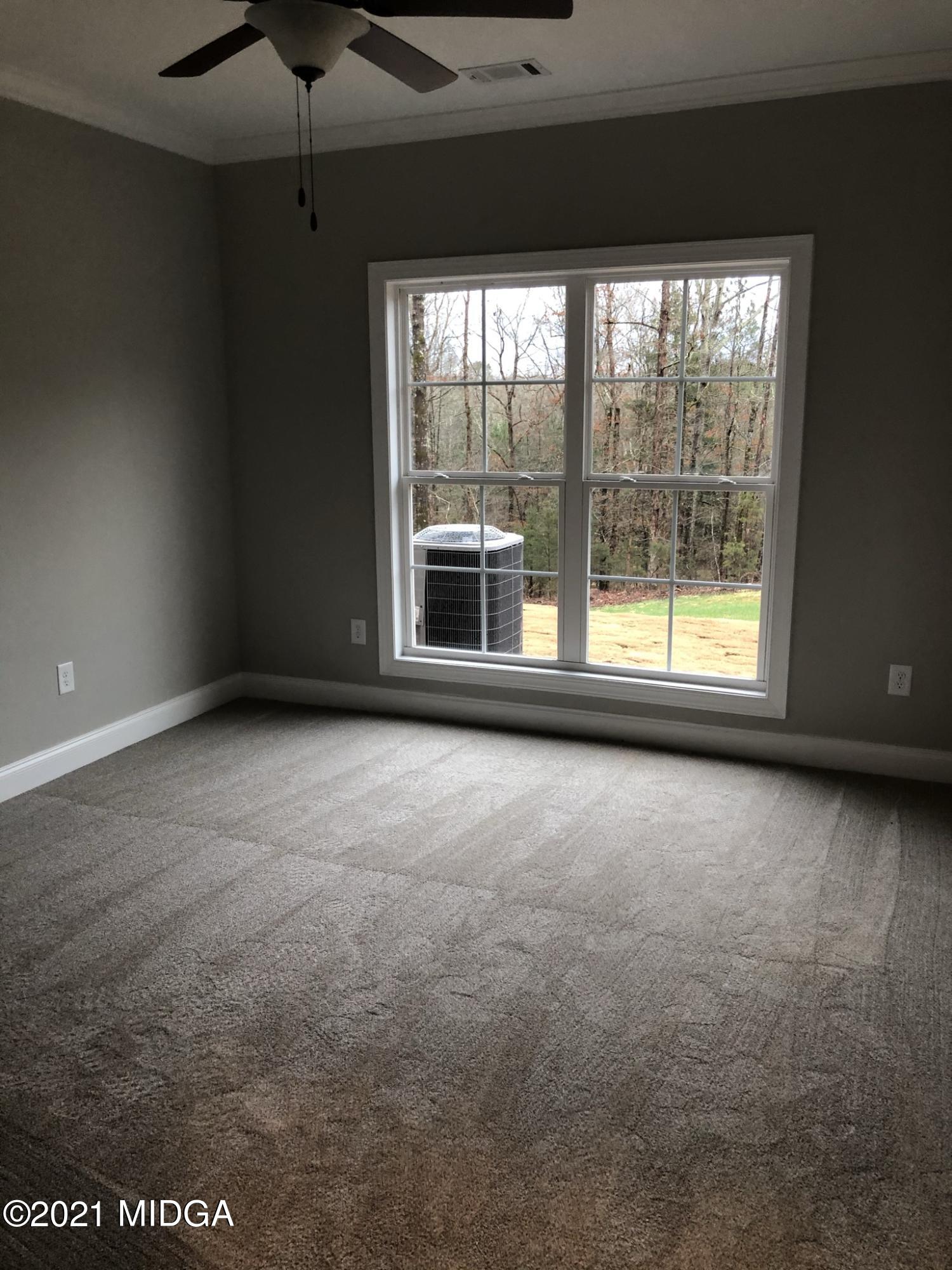 85 Adam Drive Forsyth, GA 31029 - Photo 14 of 18 a view of an empty room with a window