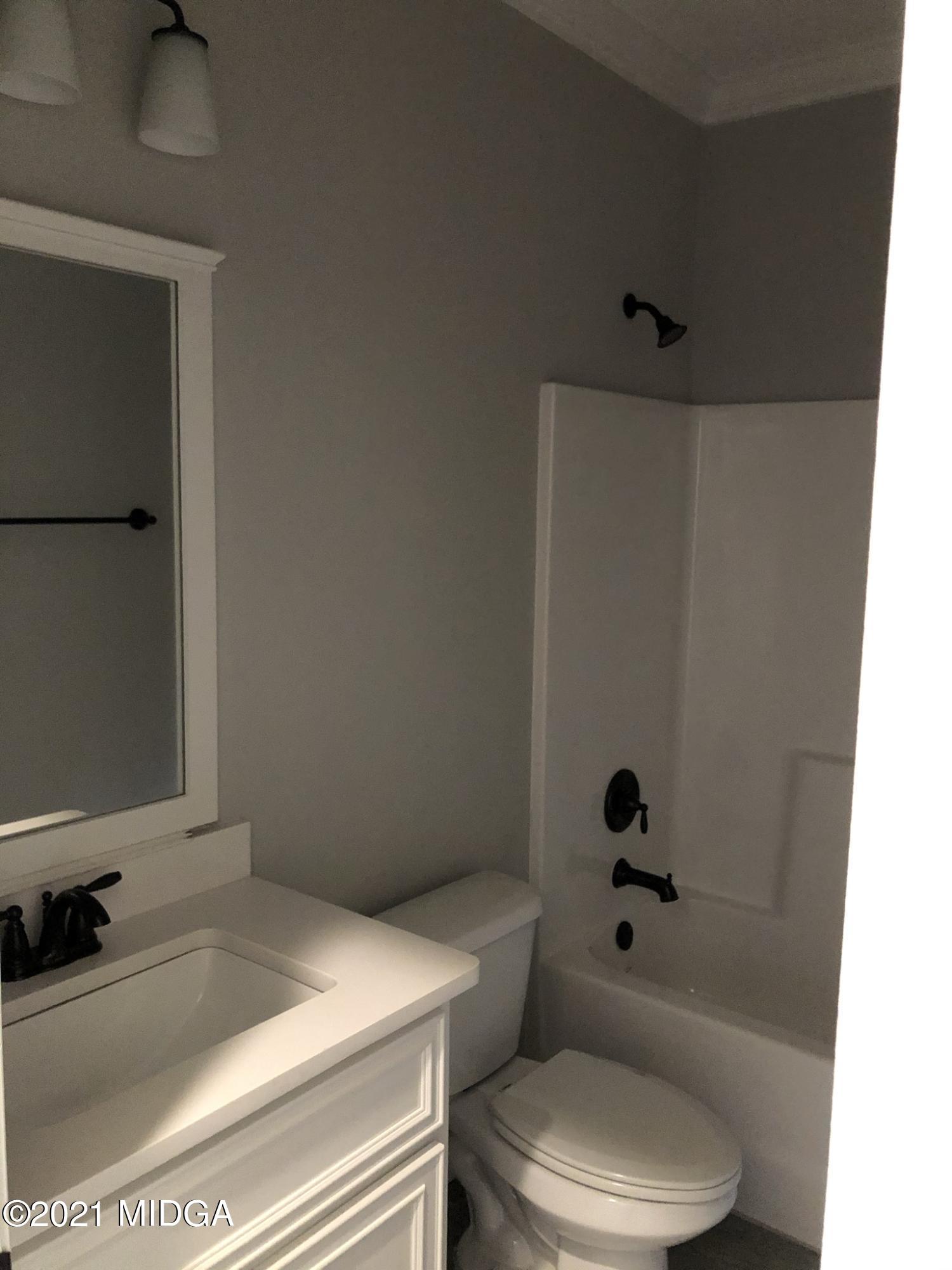 85 Adam Drive Forsyth, GA 31029 - Photo 15 of 18 a bathroom with a sink toilet and shower
